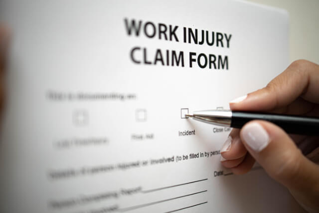Woman filling in workers injury claim form 