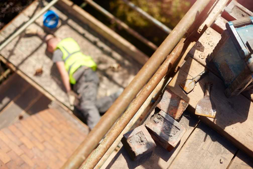 Construction worker fallen from the top of the scaffold and landed on the next level injured from fall and scaffold accident 